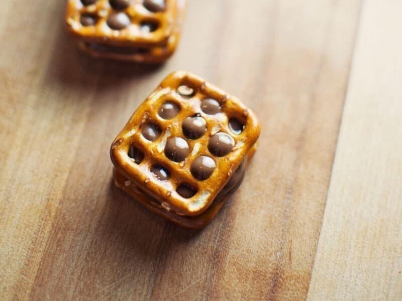 Chocolate pretzels stacked on wooden surface